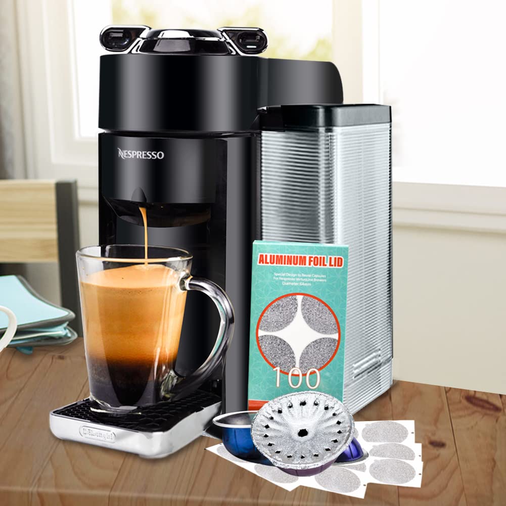 A Nespresso coffee machine brews espresso into a glass mug. Nearby, eco-friendly lids and a metal filter rest on the kitchen counter, alongside CAPMESSO's aluminum foil lids seals compatible with Vertuoline pods. The blurred background hints at a cozy dining area.