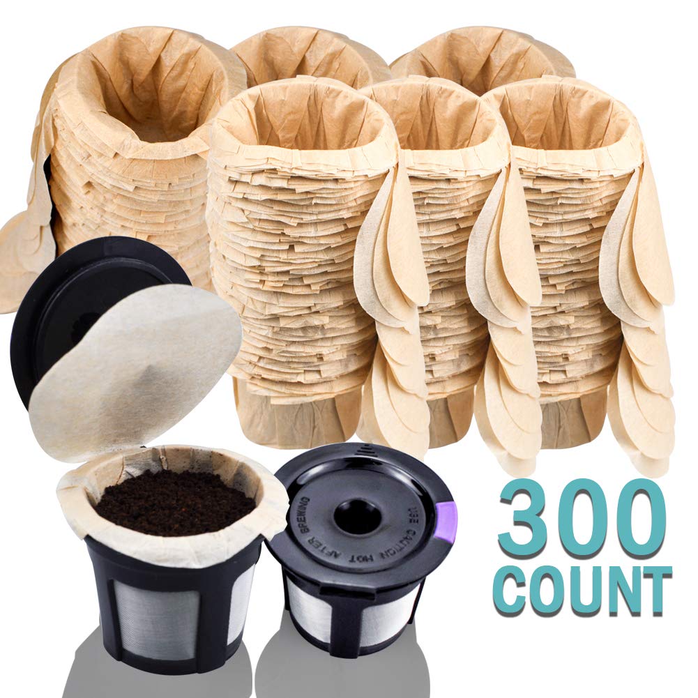 A set of brown unbleached paper coffee filters, labeled "300 count," is placed next to a pair of CAPMESSO's black and silver reusable Keurig cups, filled with ground coffee. These items are ideal for your morning coffee routine and compatible with both Keurig 2.0 and 1.0 coffee makers.